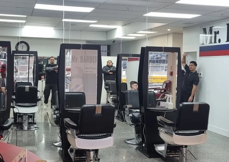 Bright modern shop interior with numbered barber stations and Mr. BARBER wall branding